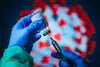 Medical worker loading Corona virus vaccine into a syringe