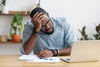 sleep deprived man working on computer