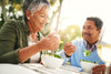 Latino man and woman eating salad